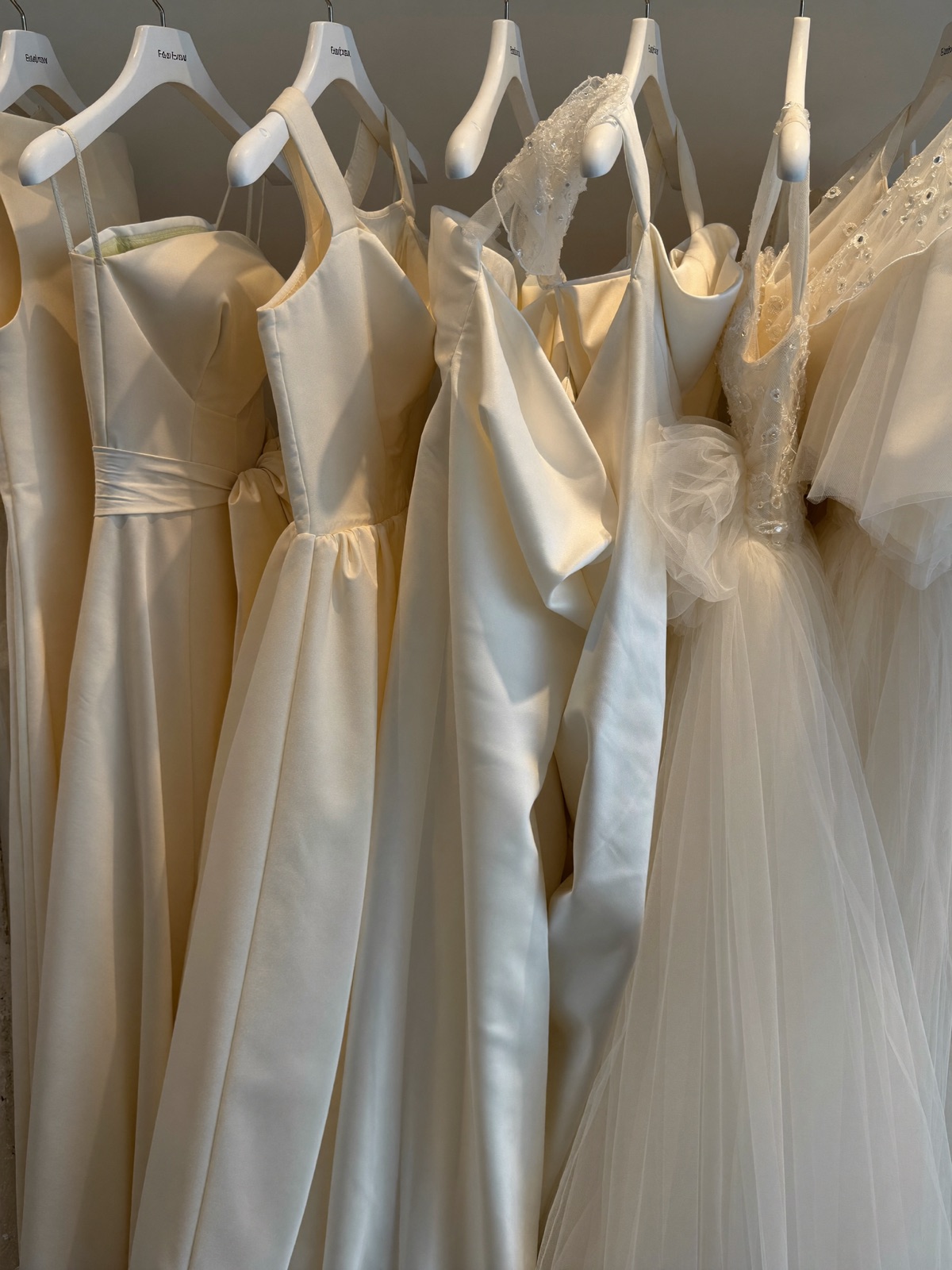 Wedding gowns on a rack inside the boutique